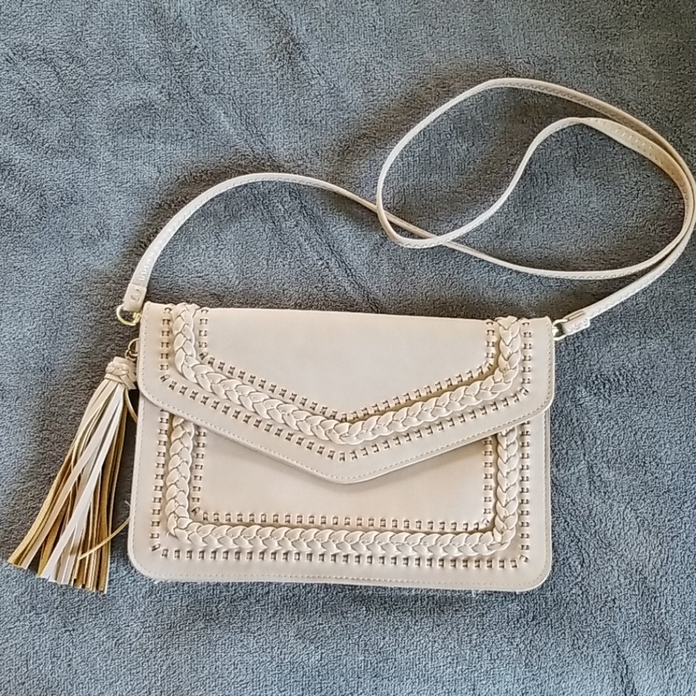 Blush crossbody with tassel and braided details